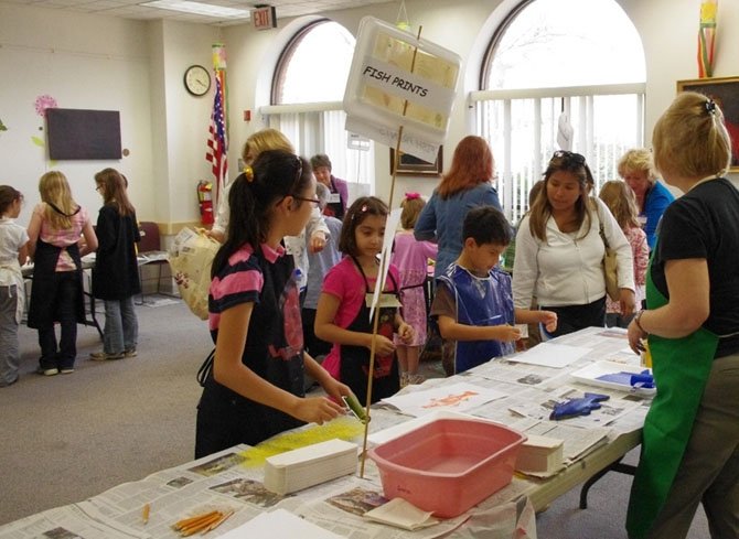 Artists from the Vienna Arts Society volunteer with children at the printmaking workshop it sponsors in cooperation with Patrick Henry Library. The next free workshop is Tuesday, March 25.
