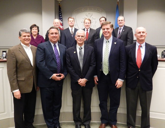 The Fairfax City Council stands to honor former Treasurer Steve Moloney. Front row, from left: are Rob Lederer, Scott Silverthorne, Moloney, Page Johnson and new Treasurer Tom Scibilia.
