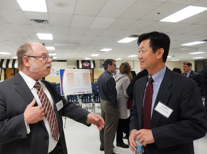 Sully District Transportation Commissioner Jeff Parnes (on left) makes a point while Young Ho Chang, a VDOT consultant, listens. In background, at right, is Supervisor Pat Herrity (R-Springfield).