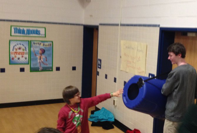 STEMbassador Andrew McCausland, a junior at Langley High School, shows how sound waves travel with the Vortex Cannon.