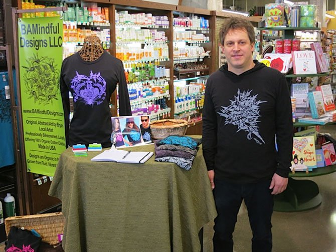 Bryan Morris of Potomac with his collection of t-shirts at Whole Foods Market in Rockville.