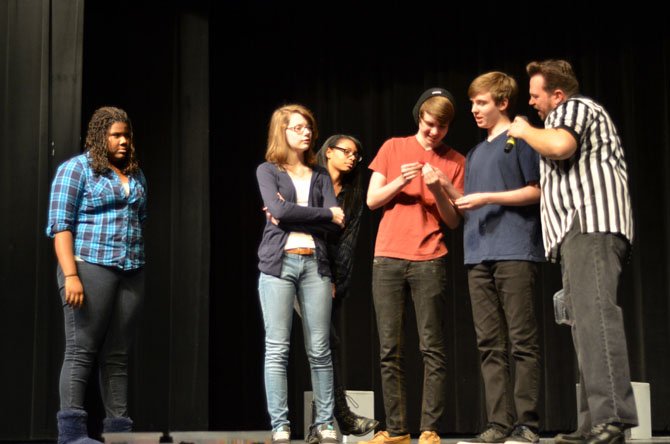 The Mt. Vernon Blue improv team learn what their scene will cover. From the left, Jordyn Stewart, Erin Harroun, Chloe Colbert, Austin Shores, and Tyler Shores, and event referee Scott D. Pafumi.