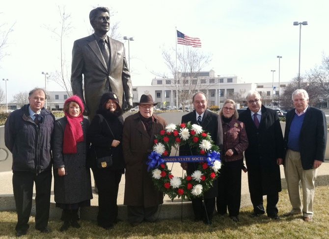 Metropolitan Washington Airports Authority vice president and airport manager Paul Malandrino (fourth from right) joins members of the DC Chapter of the Illinois State Society at a wreath-laying ceremony Feb. 6 at the airport's statue of Ronald Reagan to commemorate the former president's 103rd birthday. From are Jack Ames, Fran Griffith, Cheryl Rhoads, former Illinois state senator Mark Rhoads, Malandrino, Jeanne Jacob, Larry Krakover and Gerry Frank.