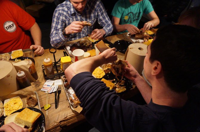 Contestants dig in to more than four pounds of food as part of the High on the Hog Challenge at Pork Barrel BBQ in Del Ray.