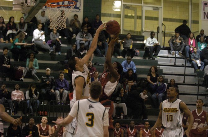 Wakefield junior Dominique Tham blocks a shot during the Warriors’ 70-48 win over Mount Vernon on Feb. 15.