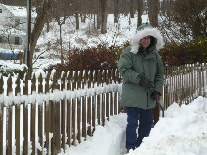 Former Clifton Mayor Jim Chesley is all bundled up while shoveling snow by his house.
