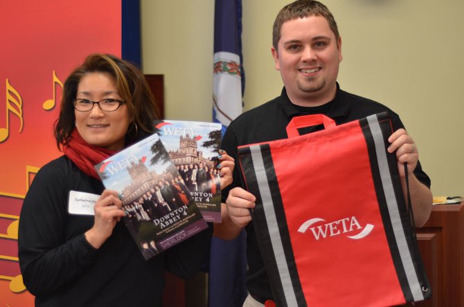 Catherine Oh and Michael Walter both display some WETA "swag" at the George Mason job fair booth.  