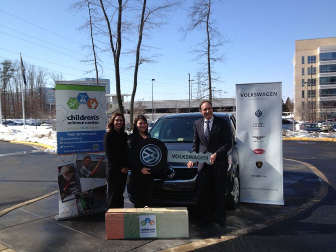 Chairman of the Board of Directors Tanya La Force (left) and Executive Director Nene Spivy accept Volkswagen’s donation from Volkswagen Group of America Vice President of Finance Gerhard Kiewel (right). 