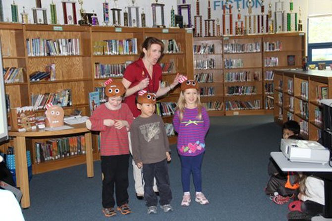 Churchill Road kindergarteners Zach Smith, Andrew Park and Kara Dinker were happy with their response on the “Gingerbread Man Quiz Show,” presented by visiting author Laura Murray.