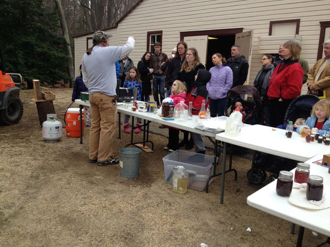 Visitors gather around park miller Mason Maddox during his demonstration.