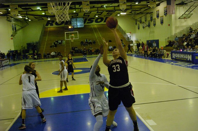 Madison junior Kelly Koshuta goes up against Stonewall Jackson senior Nicole Floyd during the 6A North region semifinals on Feb. 27 at Robinson Secondary School.