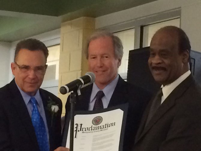 Allan Cohen, president and founder of McPaw, accepts a proclamation from County Councilmember Phil Andrews and County Executive Ike Leggett at the opening preview of the new Montgomery County Animal Services and Adoption Center on Friday, Feb. 28. Andrews and Leggett will face each other, and former County Executive Doug Duncan, in the June Democratic primary for County Executive. Cohen and McPaw were instrumental in developing the new animal center to be welcoming to the public and to focus primarily on adoption.