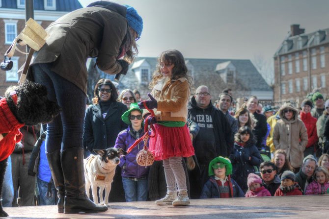  Dr. Katy Nelson of the “The Pet Show with Dr. Katy” interviews a young contestant in the owner-dog look alike contest.
