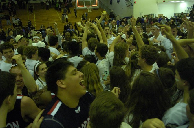 Woodson junior Giancarlo Pacheco and the Woodson Cavalry celebrate winning the 6A North region championship on March 1 at Robinson Secondary School.