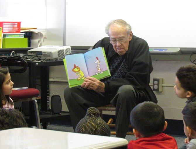 Greenspring resident, Paul Quinn, reads to students at Crestwood. Quinn, of the Catholic Council at Greenspring, was integral in the development of the reading program; he indicates that about $2400 was raised for this initiative.