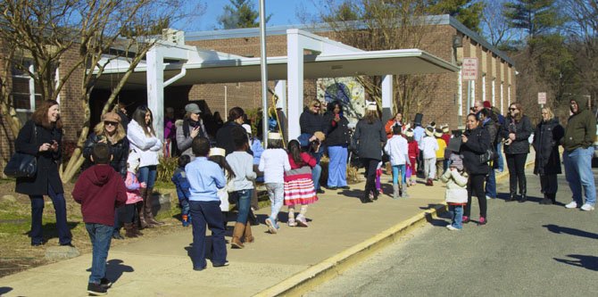 Parents lined the walkways of the school, to watch their children go by.