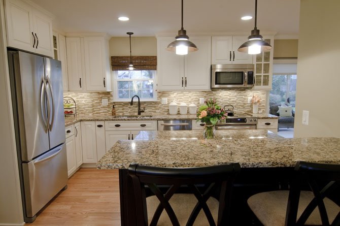 Lead designer Jon Benson removed a wall between the Borer kitchen and the dining room, adding a custom two-level food preparation surface and dining counter. The new first level floorplan "circulates beautifully," says owner Cindy Borer.