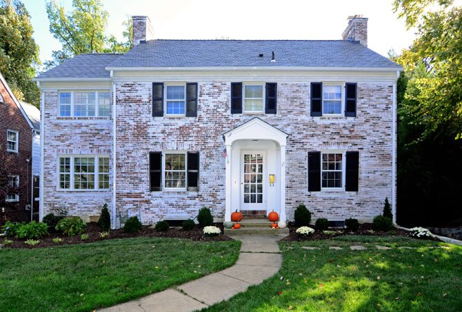 The expanded 1937 colonial features white washed brick create continuity with the side and rear additions.