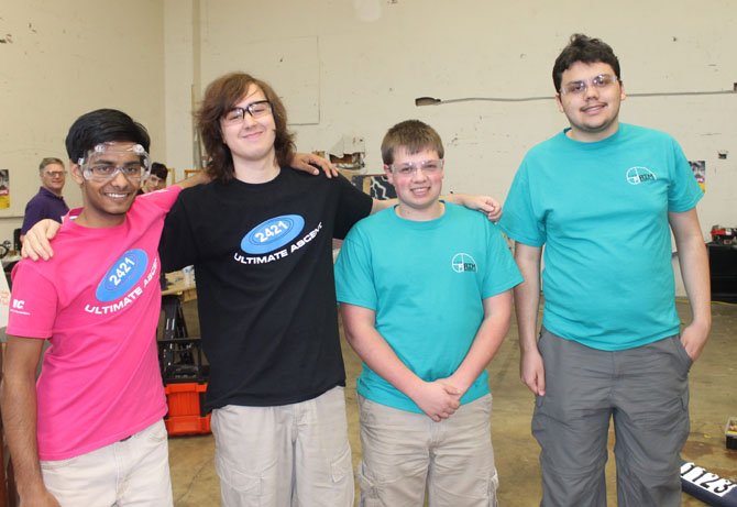 Ragav Goyal, David Kitrinos, Andrew Peace, and Ryan Beaver, co-captains of RTR Team Robotics and AIM Robotics, pose together at their practice space in Lorton.
