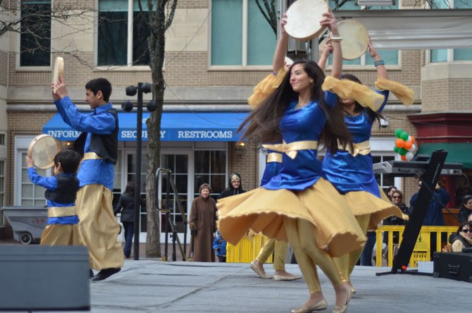 Members of Cyrus Academy in Sterling perform a dance at the 2014 Nowruz celebration at Reston Town Center. To the left are Koroush Bana and his younger brother Kiarash Bana.