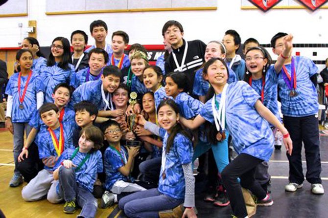 Churchill Road Science Olympiad team members, from left: Rupa Siva, Mrs. Rajee Ramesh (obscured), Brian Wang, Daniel Wen, Brandon Torng, Ethan Schoenberg, Dylan Tschampel (obscured), Ms. Jen Ezzell (obscured), Samuel Kim, Anna Krause-Steinrauf, Ethan Li, Alex Zhang (obscured), Cynthia Wang and William Wang.  Clockwise from center around trophy:  Ethan hsaio, Daniel Kalish, Eric Kim, Nolan Ward, Ryker Bendewald, Victor Bo, Ian Palk,  Katie Jeong, Austin Young, Ladan Haiderbaigi, Sahana Ramesh, Ashley Xing, and Yujin Kim.
