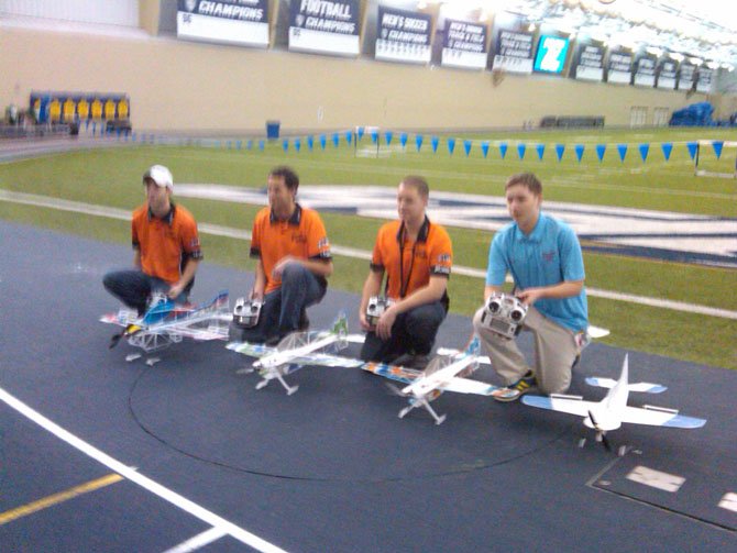 The 2015 United States Indoor Aerobatics Team with their aircraft (from left) Ryan Clark, RJ Gritter, Devon McGrath, and Joseph Szczur.
