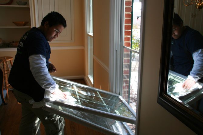 Immanuel Bible Church in Springfield coordinated the effort to finish repairs on Martin Bodrog’s house. Here, an employee of Thompson Creek installs a window, part of the $30,000 donation made to the Bodrog house.