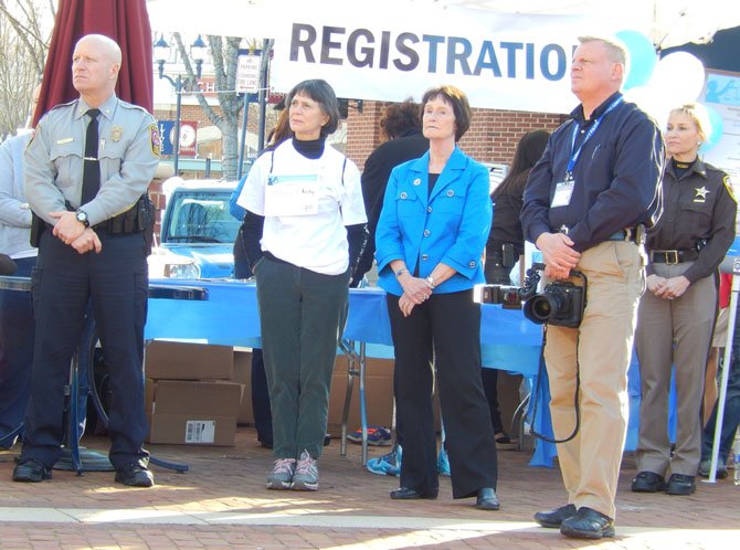 From left: Police Chief Ed Roessler Jr., Anne Haynes (Ron Kirby’s widow), Board of Supervisors Chairman Sharon Bulova, police photographer Keith Dobuler and county Sheriff Stacey Kincaid listen to the speakers.