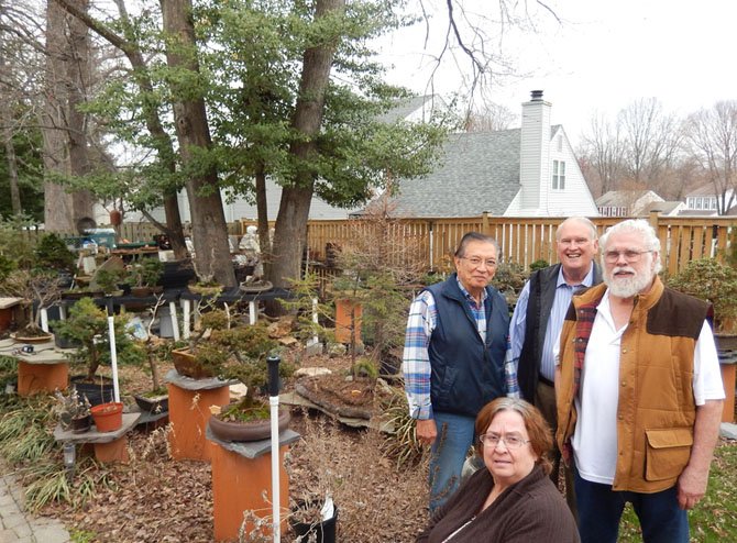 Standing near some bonsai in Chuck Croft’s yard in Burke are (from left) Joe Gutierrez, Gary Reese and Chuck Croft with Judi Schwartz (seated). 