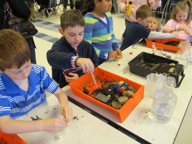 Primary-grade students partake in erosion experiments during Orange Hunt's STEM Night.