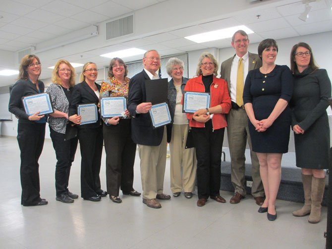 The 2014 Mayor M. Jane Seeman Award was presented to the 2013 Vienna Business Association Board of Directors. [From left] Peggy James, Mary Kay Klaus, Tracy Murphy, Kathy Georgen, George Creed, DH Scarborough, Carole Wolfand, and James Cudney, with Town Council members Carey Sienicki and Laurie DiRocco. 
