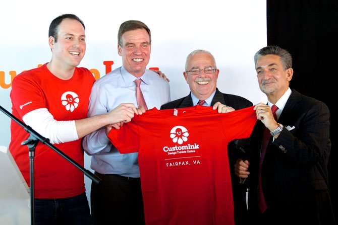CustomInk Opening Speakers: From left, CustomInk President Marc Katz, Senator Mark Warner, Congressman Gerry Connolly, and Revolution Growth Co-Founder Ted Leonsis display t-shirt at CustomInk Open House reception.