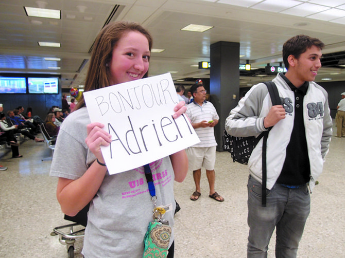 Savannah Willet, a tenth-grader at Robinson Secondary School, meets her French pen pal Adrien for the first time at Dulles on April 20. 
