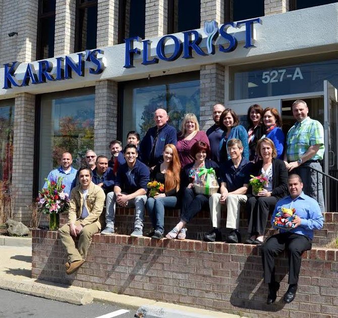 Maris Angolia (top row, fourth from right), gathered her team of award-winning designers and employees for a photo celebrating Karin’s Florist 58 years in business. The Fairfax Chamber awarded the family-owned business its 2012 Outstanding Corporate Citizenship Award for small business.
