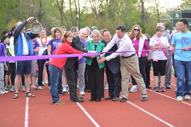 From left, McLean HS Principal Ellen Reilly, FCPS Board At Large Member Ryan McElveen, FCPS Board Dranesville District Member Jane Strauss, FCPS Board Chairman Ilryong Moon and Langley HS Principal Matt Ragone get things started cutting the ribbon on the 2014 Relay for Life event at Langley High School.