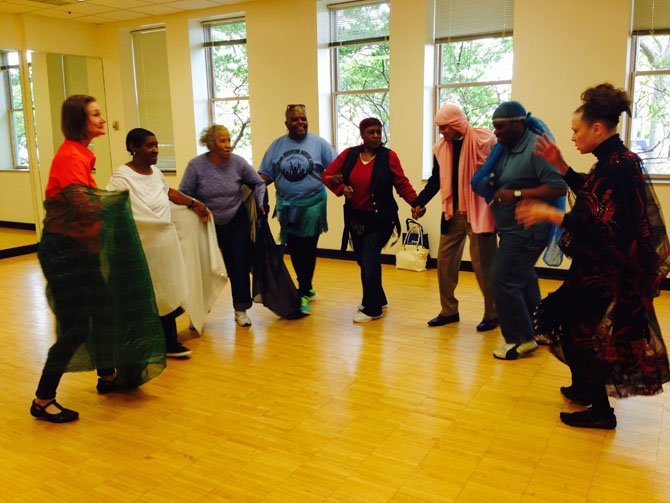 Participants take part in belly dancing.
