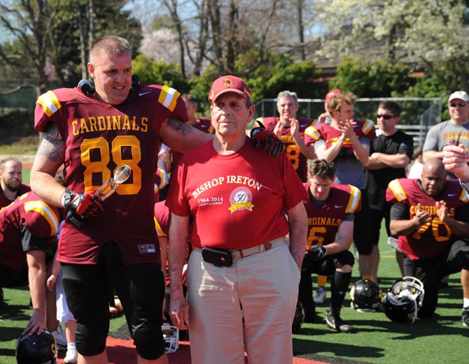 Charles O'Malley, right, stands along the sidelines of Fannon Field with Derek Radoski (BI '89) at the April 12 Bishop Ireton alumni football game to raise money for the Sean O'Malley scholarship fund.