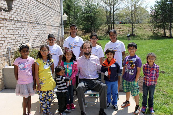 Mount Vernon district school board member Dan Storck poses with participants of the Magic of Mothers Math Mania competition in Fairfax Station on April 26.