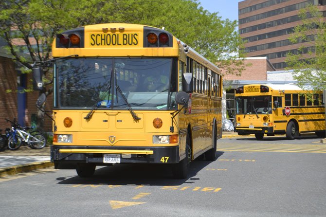 School buses park outside of Arlington's Key Elementary School. 
