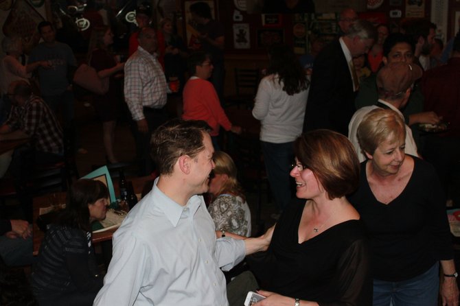 Lisa Merkel chats excitably at Jimmy’s Old Town Tavern after finding out she won the Herndon Town election for mayor.