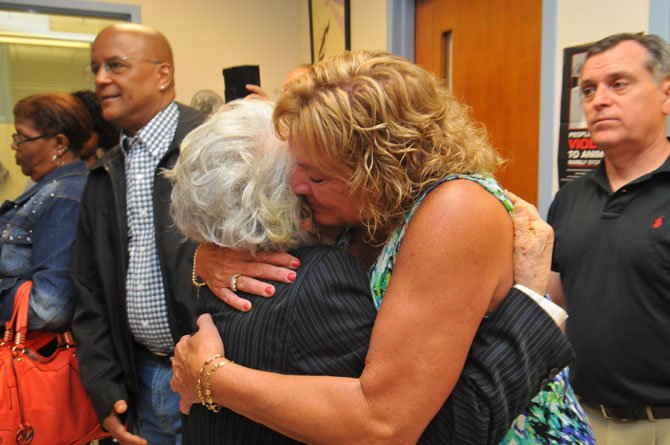 Longtime friend of the family Marjorie Harris gives Virginia Smith’s daughter Renee a hug at the conclusion of the ceremony. 