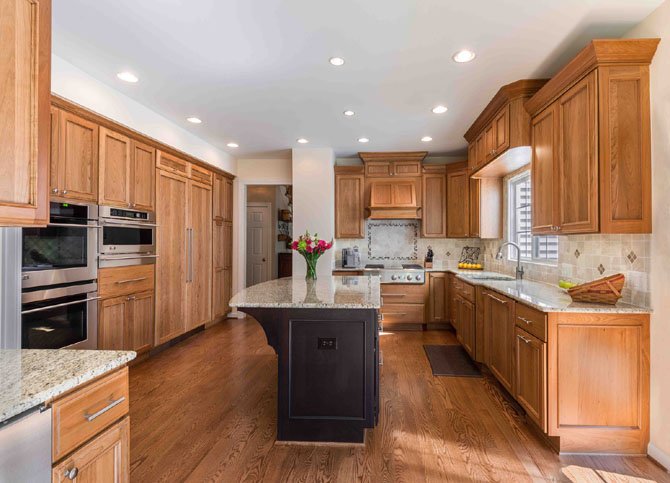 While staying within the footprint of their existing 18-year old-kitchen, Dave and Cindy Kuntzman gained significant improvements in both function and design. Cindy Kunzman worked closely with designer Mimi Lee at Foster Remodeling Solutions in developing a warmly textured ambiance that combines selected hardwoods, tumbled marbles and granite. Foster increased storage capacity and introduced a much larger food preparation island without moving walls or adding square footage.