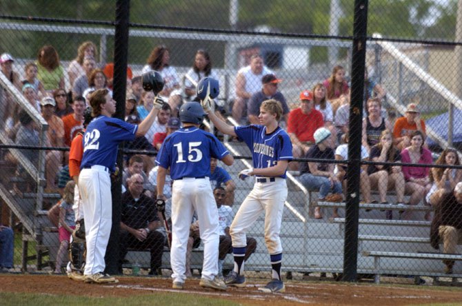 West Potomac sophomore Jamie Sara, right, is greeted at home plate by teammates Billy Lescher (22) and Rocky Iboleon (15) after hitting a two-run home run in the first inning against West Springfield on May 13.