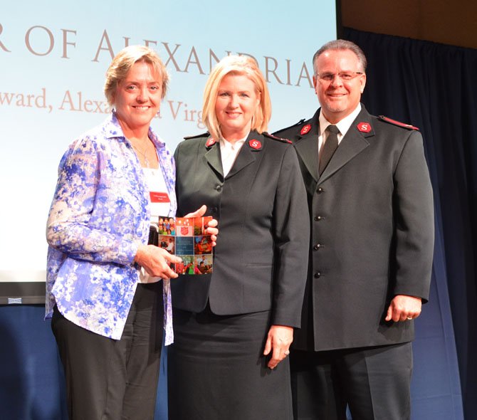 ServiceMaster of Alexandria owner Jane Gandee is honored as a key community partner by Majors Lewis and Jacqulyn Reckline of the Salvation Army National Capital Area Command at the United in Service breakfast May 13 at Hamilton Live in Washington.
