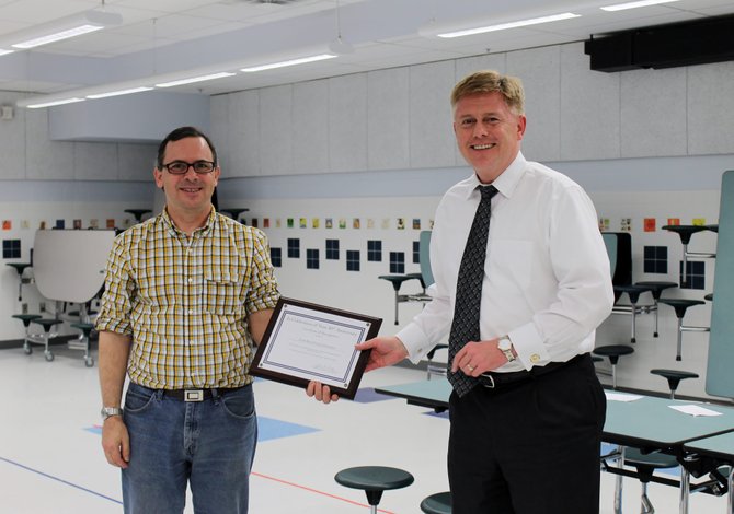 Supervisor John Cook presents the president of the Little Run Citizen’s Association with an award in celebration of the association’s 50th anniversary.