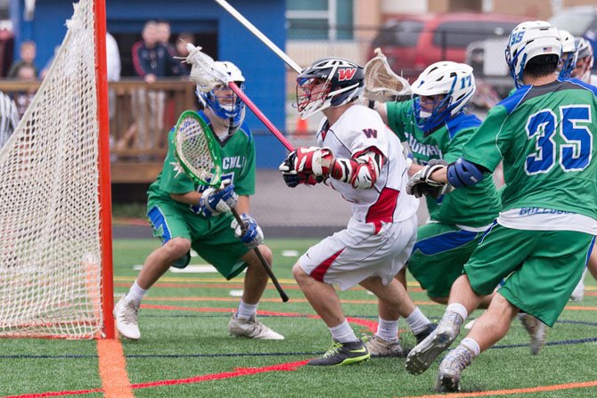 Wootton junior Myles Romm is surrounded by the Churchill defense near the goal on May 14.