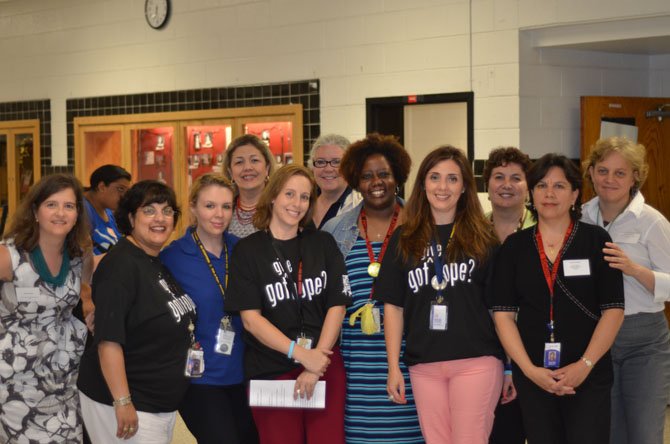 Individuals who organized the Herndon High presentation on Human Trafficking assemble for a photo. In the center is social worker Heather Coleman.
