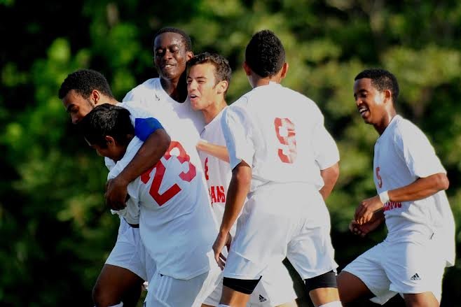 The Titans celebrate during the Conference 7 boys' soccer championship match against South County on Thursday.