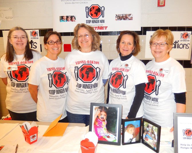 (From left) Katherine Hall, Julie Moore, Molly Quackenbush and Sue Hamblen, all of Vienna Presbyterian Church, and Gretchen Thiele of Emmanuel Lutheran Church, man the donation table.