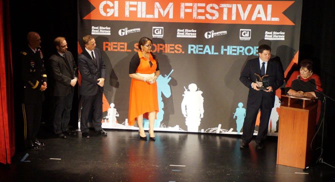 The sister and college roommate of the late actor James Gandolfini, right, accept an award on his behalf during the GI Film Festival Salute to Hollywood Patriots night May 23 at the Old Town Theatre.